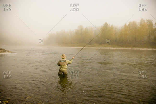 Fisherman angling in the Elk River at East Kootenays, British Columbia, Canada