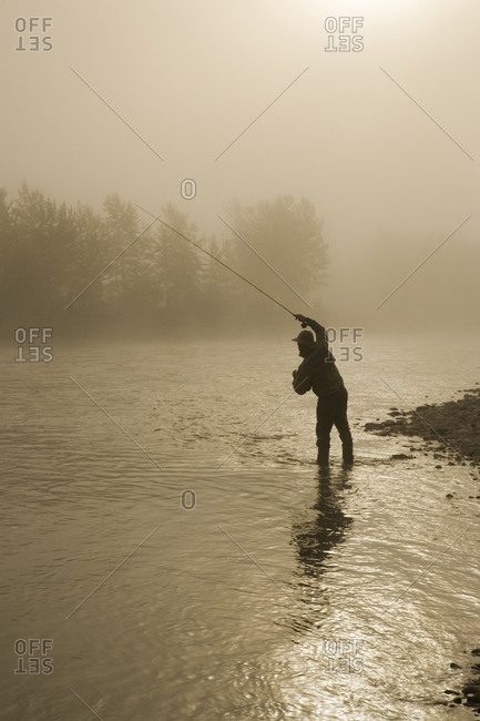 Man angling in the Elk River at East Kootenays, British Columbia, Canada