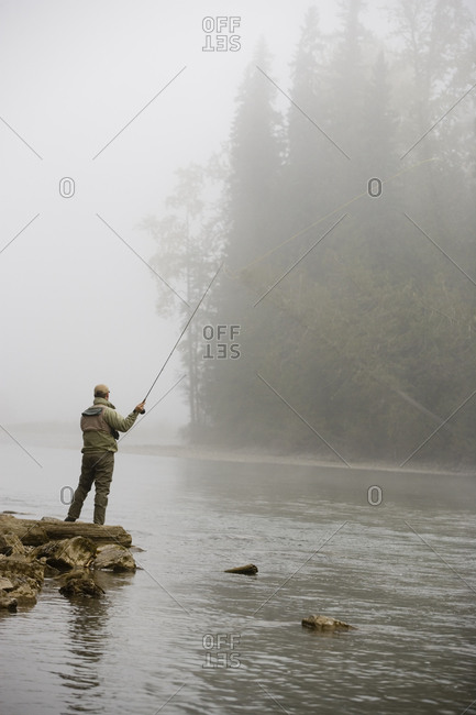 Man fly-fishing at the Elk River in East Kootenays, British Columbia, Canada