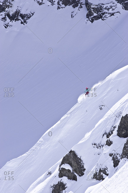 Woman skiing down a steep slope in Fernie, Canada