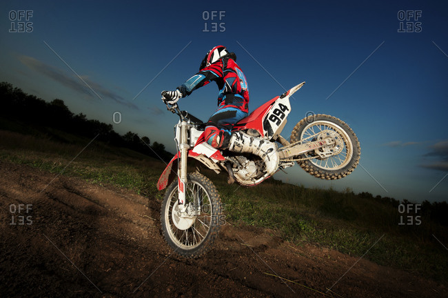 Motocross rider performing a stunt with his bike