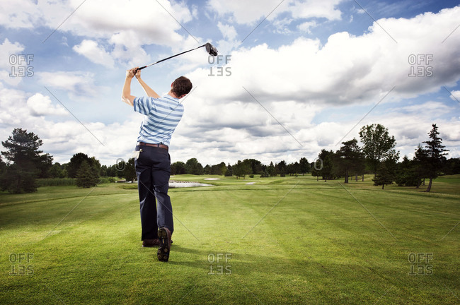 Golfer teeing off in a golf course