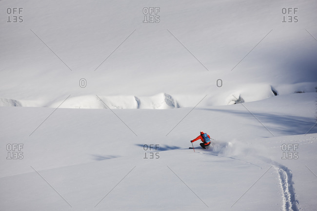 Man downhill skiing on a snowy slope