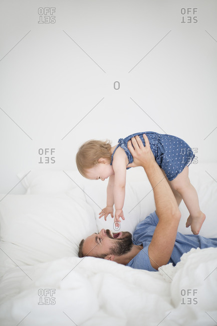 Father lifting up her daughter