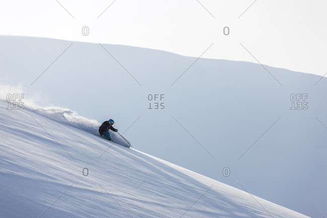 Man backcountry skiing on a snowy slope