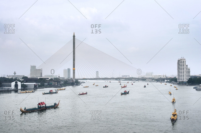 Boats traveling by Rama VIII Bridge