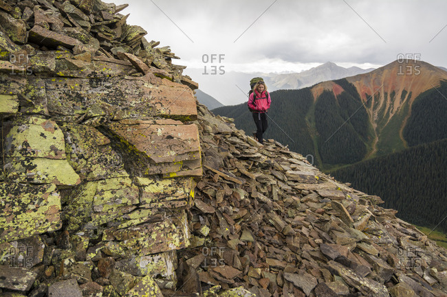 Woman hiking analpine  trail into Columbine Lake, San Juan National Forest,  Silverton, Colorado