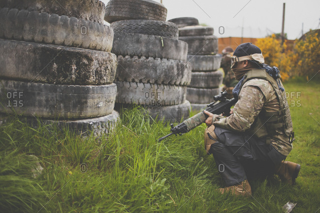 Soldier hides behind tire barricade