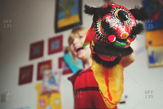 A little girl holds a Chinese dragon puppet in celebration of Chinese New Year