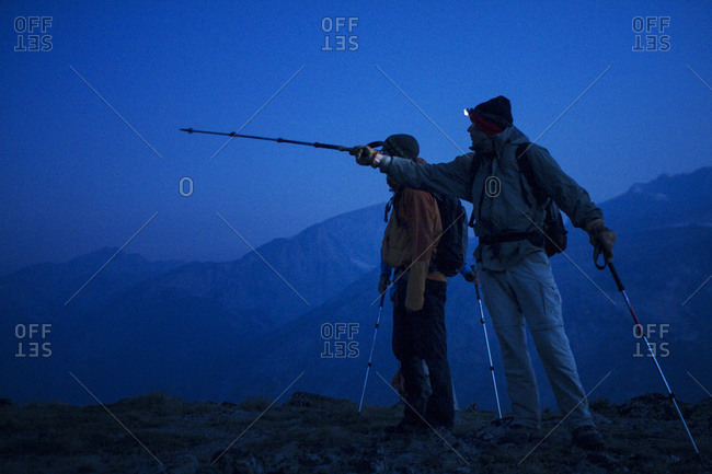 Two men hiking at night