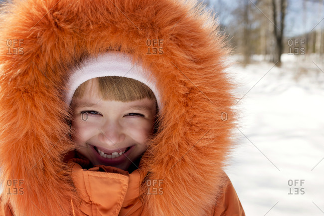 A girl in an orange furry parka