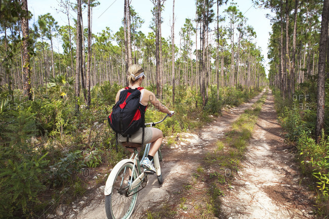 Woman riding down tropical trail in the Bahamas