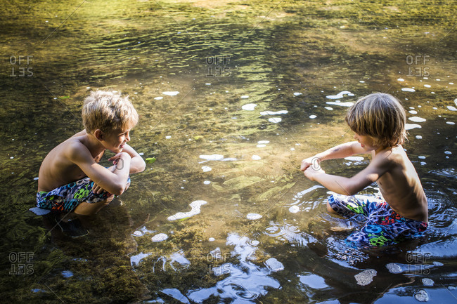 Brothers playing in the river