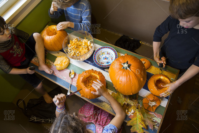 Kids carving pumpkins for Halloween