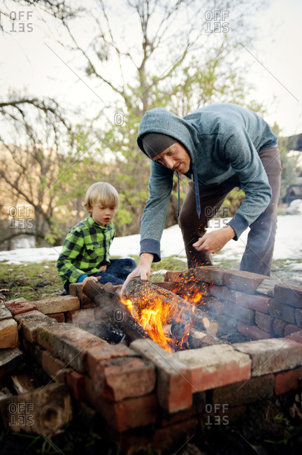 Father teaching son how to make a fire