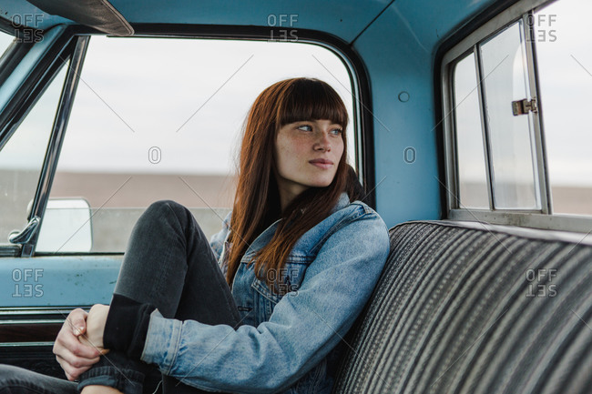Passenger door view of woman sitting in a pickup truck