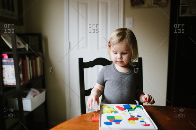 Girl playing with pattern blocks