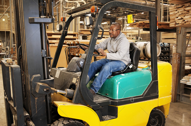 Forklift operator in furniture factory