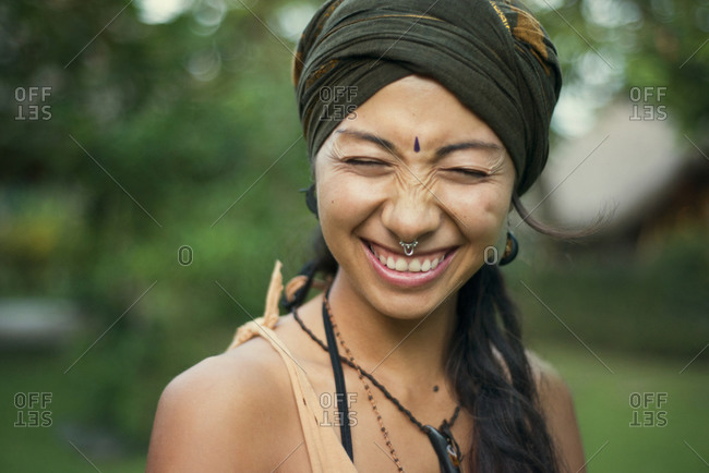 Young woman with nose ring and bindi smiling