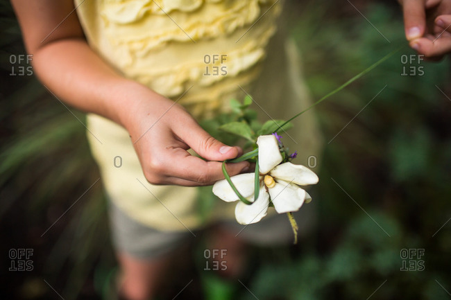 Young girl holding a white flower