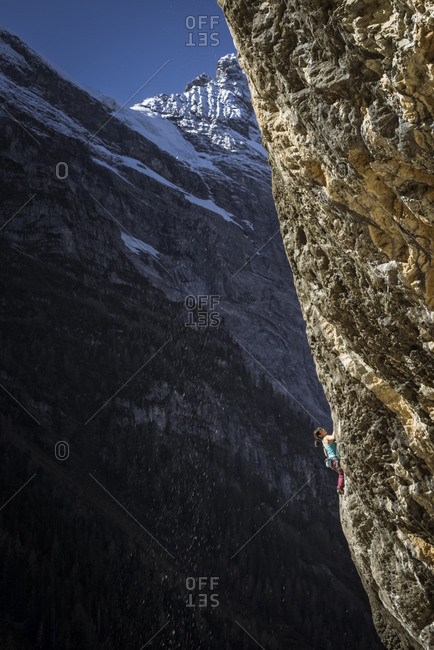 Woman climbing cliff in Gimmelwald, Switzerland