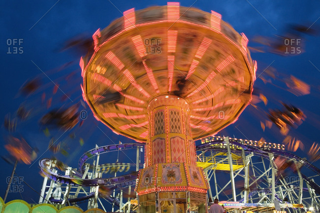 Illuminated fairground rides at night