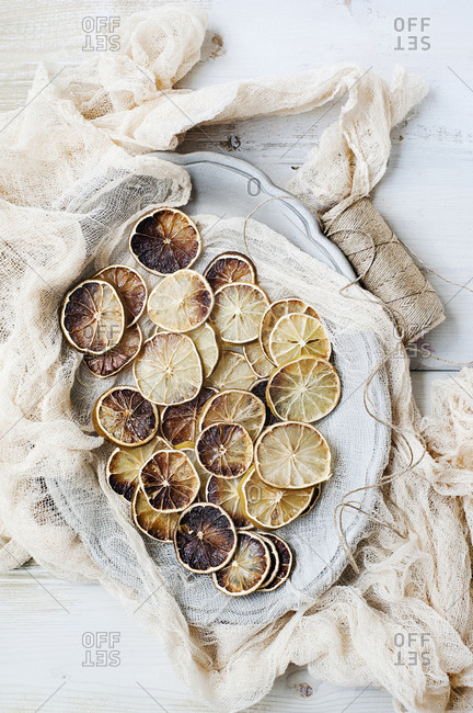 Dried lemon slices on plate with cheesecloth