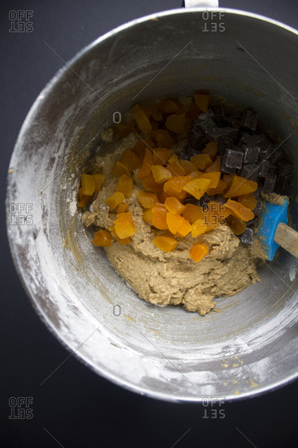 Dried fruit being mixed into batter