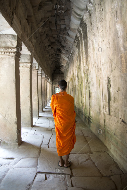 Monk wandering Angkor archeological complex