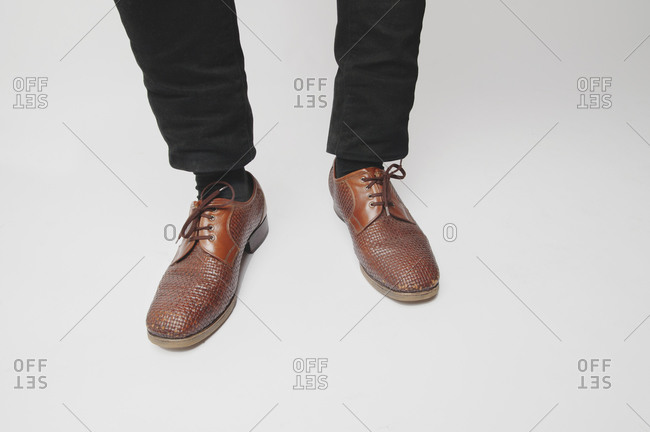 Feet of man with woven dress shoes