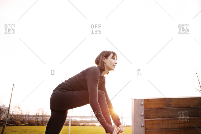 Woman tying her shoelaces in park