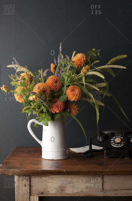 Flower bouquet with orange pom-pom dahlias and lavender