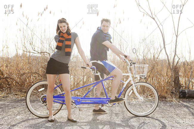 Man and woman sitting on tandem bike together