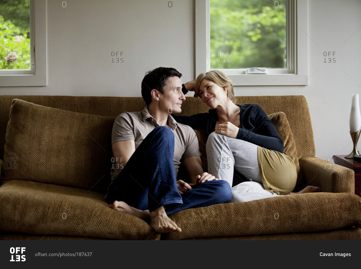 Romantic Couple Talking Indoors On Sofa Stock Photo Offset