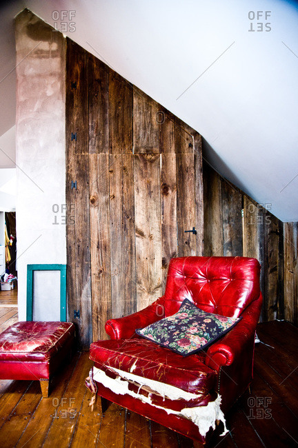Red armchair with barn wood walls