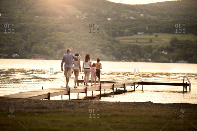 A family walks out onto a dock together