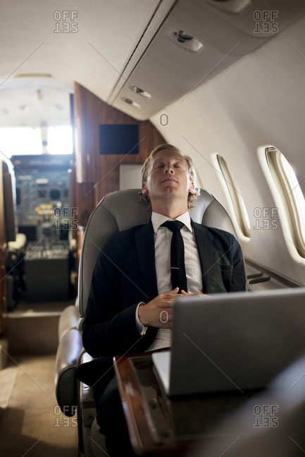 Businessman napping on his private jet