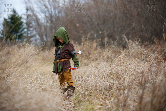 Boy in Robin Hood costume with bow and arrow