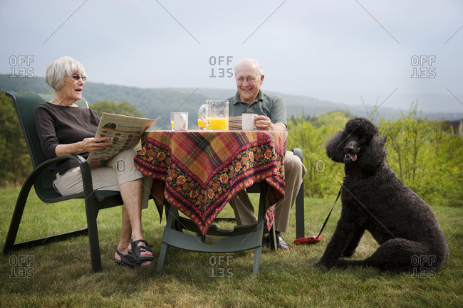 Senior couple having breakfast in the garden