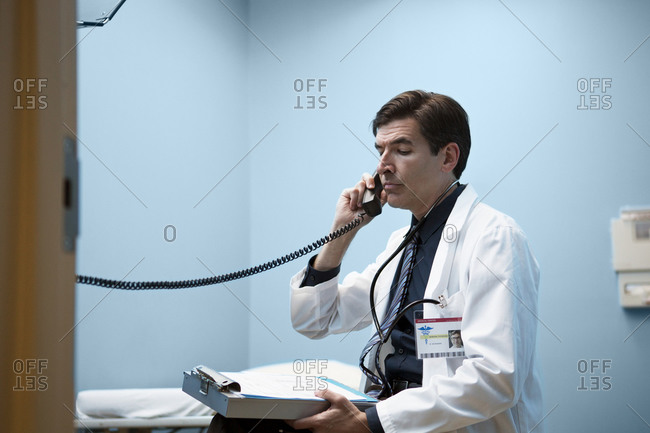 Doctor on the phone in a patient exam room