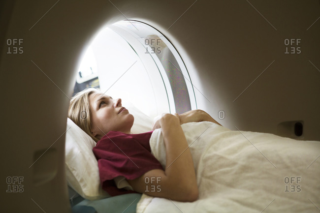Young woman looking up in a diagnostic imaging machine
