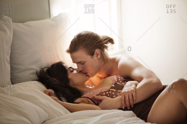 Couple making out in bed