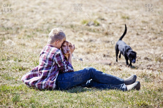 Young boy hugging a dog