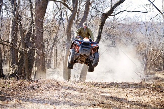 Man riding a quad in the woods