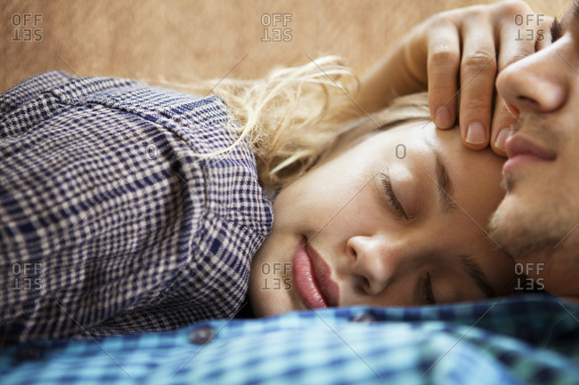 Woman Laying On Man S Chest On Couch Stock Photo Offset