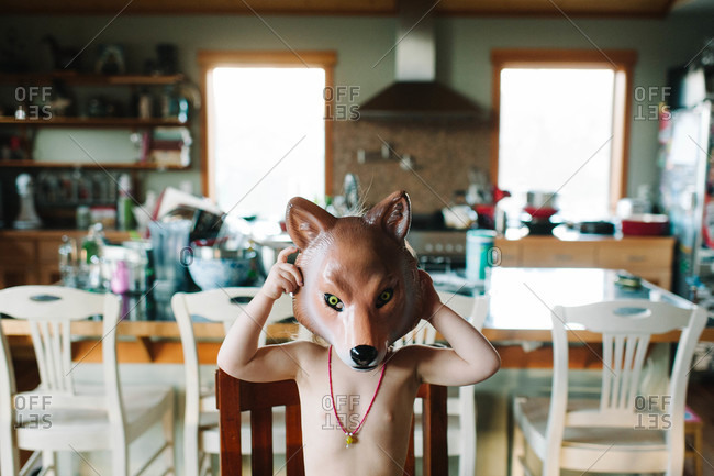 Child putting on a wolf mask