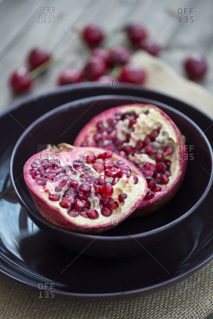 Pomegranate and cherry fruits in a bowl