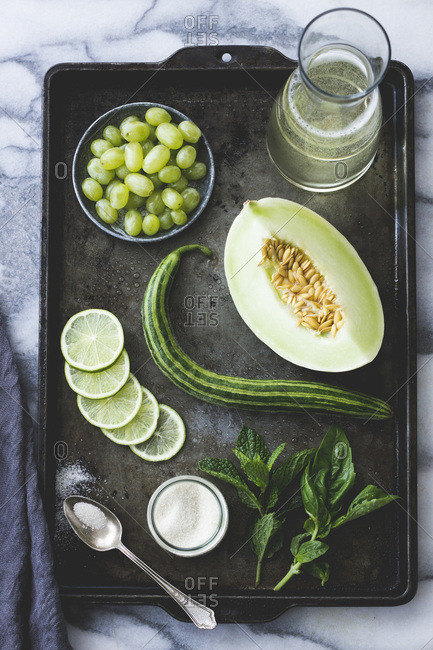 Green fruits and vegetables on a baking tray