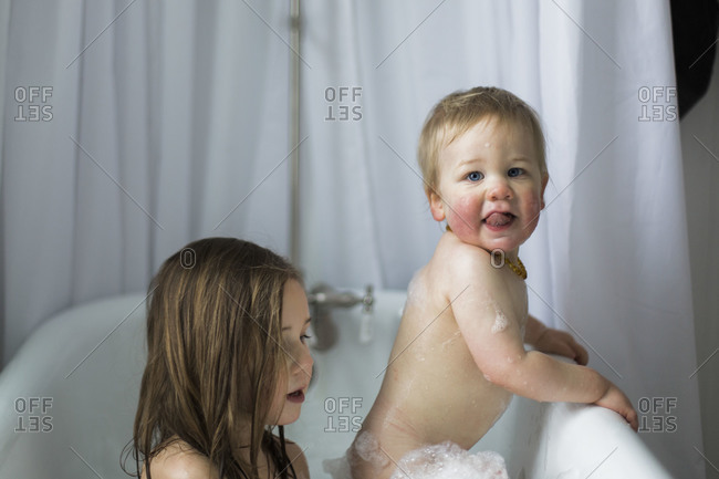 Two young children enjoying a bath together
