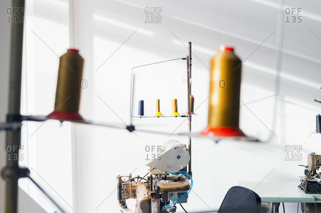 Thread spools and sewing machines in studio
